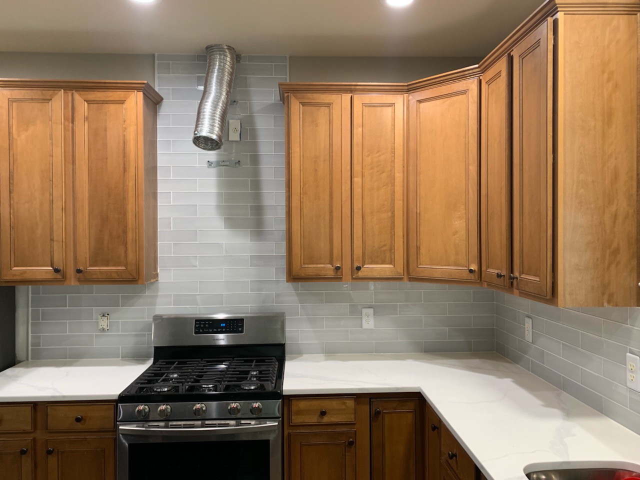 Glass tile backsplash with quartz countertops
